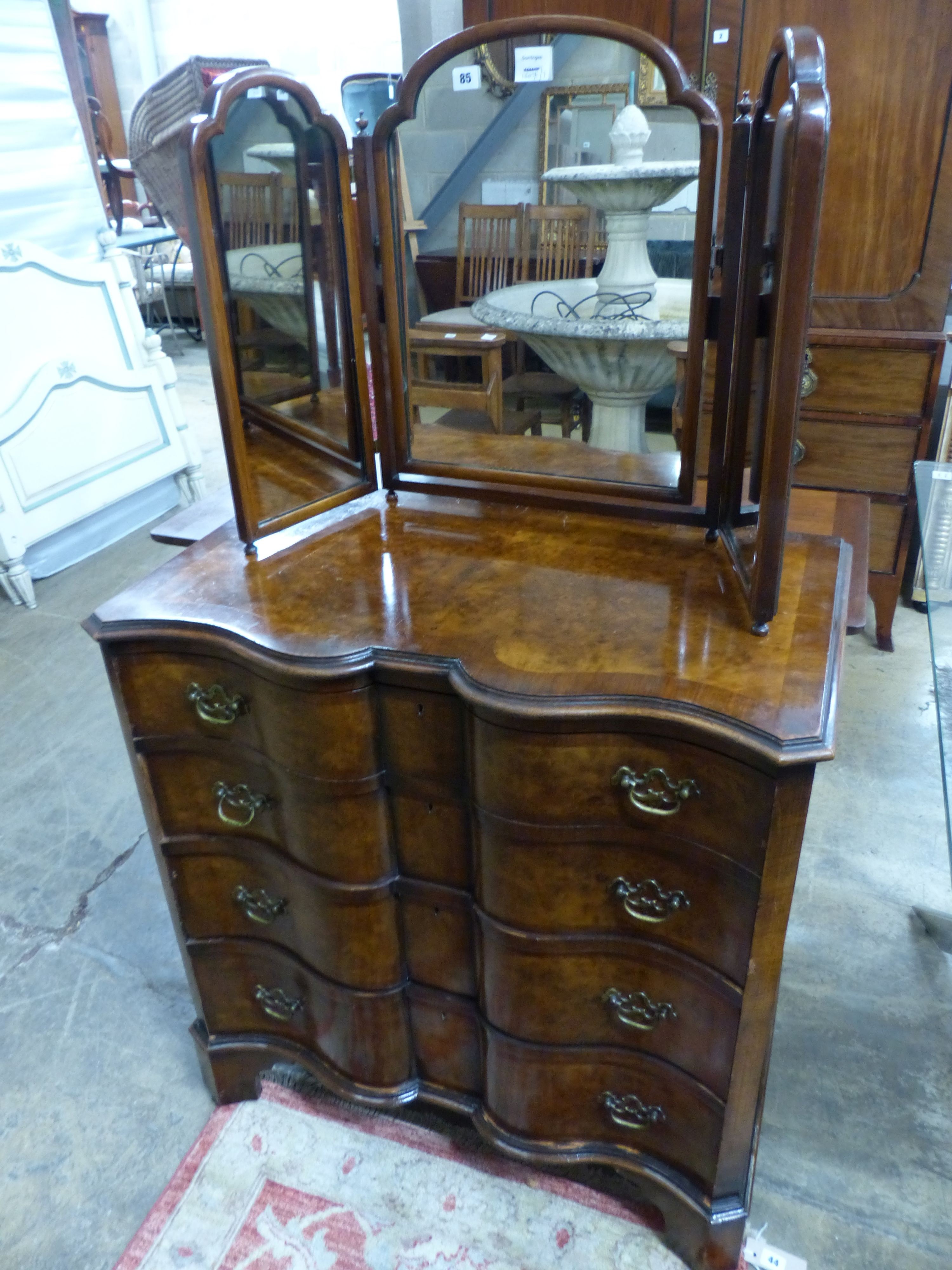 A Queen Anne Revival shaped front walnut chest, W.84cm D.49cm H.88cm, and a walnut triple dressing mirror